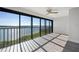 Living room with water view and sliding glass doors at 1751 Beach Rd # 404, Englewood, FL 34223