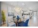 Elegant dining room features a glass-top table and chairs, with a view into the kitchen at 17530 Northwood Pl, Bradenton, FL 34202