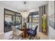 Bright dining room with a round glass table and four chairs, overlooking the backyard at 17530 Northwood Pl, Bradenton, FL 34202