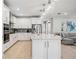 Modern kitchen with white cabinets, large island, and stainless steel appliances at 17530 Northwood Pl, Bradenton, FL 34202