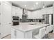 Modern kitchen with white cabinets, gray backsplash and stainless steel appliances at 17530 Northwood Pl, Bradenton, FL 34202