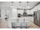 Modern kitchen with white cabinets, a large island, and stainless steel appliances at 17530 Northwood Pl, Bradenton, FL 34202
