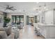 Open concept kitchen with white cabinets, island seating, and stainless steel appliances at 17530 Northwood Pl, Bradenton, FL 34202