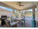 Spacious lanai with seating area, pool view, and grill at 17530 Northwood Pl, Bradenton, FL 34202