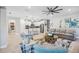 Open concept living room and kitchen with gray sectional sofa and white kitchen island at 17530 Northwood Pl, Bradenton, FL 34202