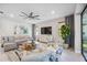 Living room with comfortable seating, a large TV, and a modern coffee table at 17530 Northwood Pl, Bradenton, FL 34202