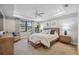 Spacious main bedroom with a king-size bed, large window, and a sitting area at 17530 Northwood Pl, Bradenton, FL 34202