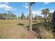 Landscaped side yard with mature trees and grassy area at 17530 Northwood Pl, Bradenton, FL 34202
