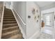 Elegant staircase with neutral carpeting and wall decor at 17530 Northwood Pl, Bradenton, FL 34202