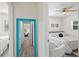 Hallway with teal mirror reflecting living room view at 1909 23Rd W Ave, Bradenton, FL 34205