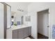 Bathroom with gray vanity, walk-in shower, and linen closet at 21536 Palatka Dr, Venice, FL 34293