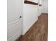 Bright hallway with wood-look tile flooring and floating shelves at 21536 Palatka Dr, Venice, FL 34293