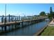 Wooden community dock with boats moored at 2601 Gulf N Dr # B16, Bradenton Beach, FL 34217