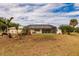 Large backyard showcasing the home's exterior and pool at 27425 Jones Loop Rd, Punta Gorda, FL 33982