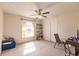 Bright bedroom with ceiling fan and carpeted floor at 27425 Jones Loop Rd, Punta Gorda, FL 33982