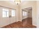 Bright entryway with hardwood floors, double doors, and view of living room at 27425 Jones Loop Rd, Punta Gorda, FL 33982