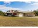 Single-story home with metal roof, screened porch, and attached garage at 27425 Jones Loop Rd, Punta Gorda, FL 33982