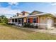 Tan house with red shutters, screened porch, and metal roof at 27425 Jones Loop Rd, Punta Gorda, FL 33982