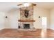 Stone fireplace with wooden mantel in a large living room at 27425 Jones Loop Rd, Punta Gorda, FL 33982