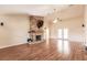 Spacious living room with stone fireplace and hardwood floors at 27425 Jones Loop Rd, Punta Gorda, FL 33982