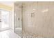 Walk-in shower with marble tile and glass enclosure at 27425 Jones Loop Rd, Punta Gorda, FL 33982