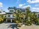 A modern, two story home with a rooftop deck and a landscaped yard at 3015 Avenue E, Holmes Beach, FL 34217