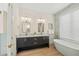 Elegant bathroom with double vanity, soaking tub, and walk-in shower at 3015 Avenue E, Holmes Beach, FL 34217