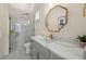 Modern bathroom with a frameless shower and gray vanity at 3015 Avenue E, Holmes Beach, FL 34217