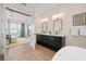 Stunning bathroom with double sinks, a bathtub and bedroom view at 3015 Avenue E, Holmes Beach, FL 34217