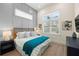 Comfortable bedroom with gray accent wall, king-size bed, and natural light at 3015 Avenue E, Holmes Beach, FL 34217