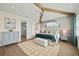 Main bedroom with a four poster bed, and ensuite bathroom at 3015 Avenue E, Holmes Beach, FL 34217