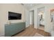 bedroom with built-in TV, dresser, and en-suite bathroom at 3015 Avenue E, Holmes Beach, FL 34217