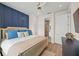 Spacious bedroom with king-size bed, navy accent wall, and access to bathroom at 3015 Avenue E, Holmes Beach, FL 34217