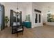 Bright dining room with large windows and a teal accent wall at 3015 Avenue E, Holmes Beach, FL 34217