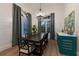 Elegant dining room with a large chandelier and teal cabinetry at 3015 Avenue E, Holmes Beach, FL 34217