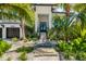 Inviting front entrance with lush landscaping and a paved walkway at 3015 Avenue E, Holmes Beach, FL 34217