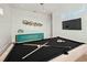 Well-lit game room with pool table, TV and stylish decor at 3015 Avenue E, Holmes Beach, FL 34217