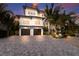 Beautiful beach house exterior with a paved driveway at 3015 Avenue E, Holmes Beach, FL 34217