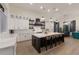 Modern kitchen with white cabinets, marble countertops, and large island at 3015 Avenue E, Holmes Beach, FL 34217
