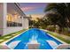 Luxury pool with lounge chairs, surrounded by lush landscaping at 3015 Avenue E, Holmes Beach, FL 34217