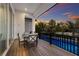 Relaxing pool deck with outdoor dining set and view of a tranquil pool at sunset at 3015 Avenue E, Holmes Beach, FL 34217