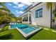 Relaxing pool and spa with artificial turf and lounge chairs at 3015 Avenue E, Holmes Beach, FL 34217