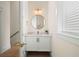 Modern powder room with white vanity, marble countertop, and gold accents at 3015 Avenue E, Holmes Beach, FL 34217