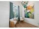 Cozy sitting area with two wicker chairs, large artwork, and natural light from a window at 3015 Avenue E, Holmes Beach, FL 34217