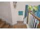 Wooden staircase with teal colored accent wall at 3015 Avenue E, Holmes Beach, FL 34217