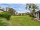 Lush backyard with a pond view and well-maintained landscaping at 3102 Windrush Bourne # 4, Sarasota, FL 34235