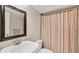 Bathroom features a large mirror, a vanity sink, and a shower with a striped curtain at 3102 Windrush Bourne # 4, Sarasota, FL 34235