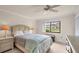 Cozy bedroom with a queen-size bed and a view of the serene pond at 3102 Windrush Bourne # 4, Sarasota, FL 34235