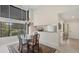 Elegant dining area with a chandelier and large windows providing natural light at 3102 Windrush Bourne # 4, Sarasota, FL 34235