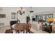 Spacious living room with chandelier, ample seating, and sliding doors to the exterior at 3102 Windrush Bourne # 4, Sarasota, FL 34235